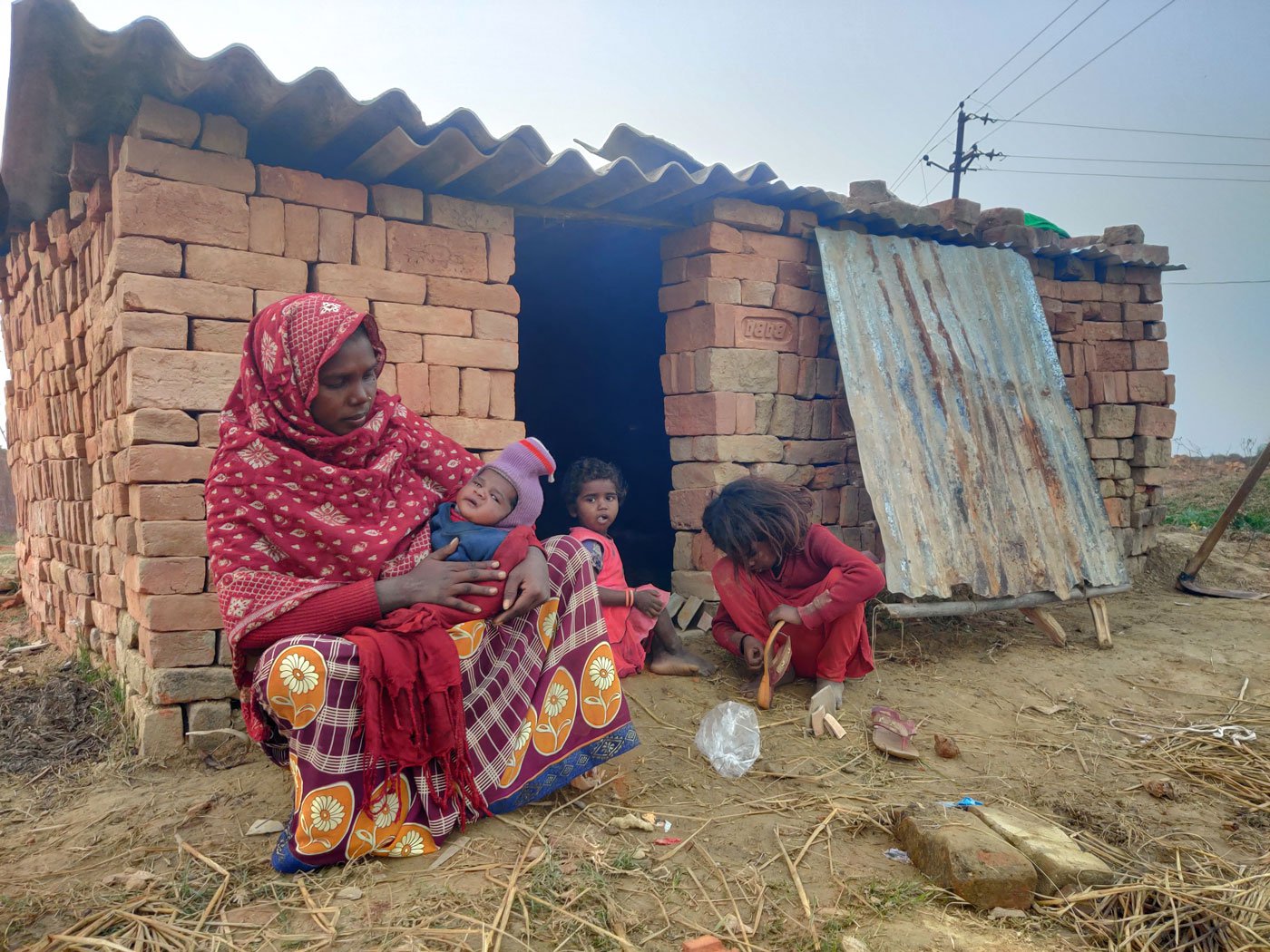 Lakshima with her infant son Amar, and daughters Resham (in red) and Renu. She remembers the pain of losing a child three years ago, when the staff of a primary health centre refused to admit her