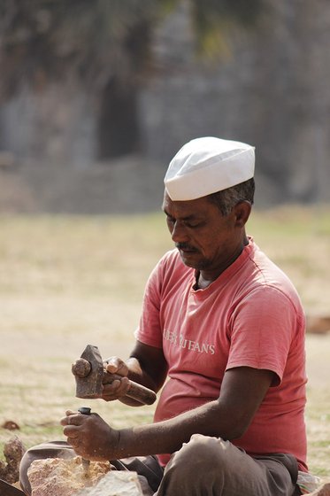 Tukaram Pawar busy with his daily work of chiseling the stones. 