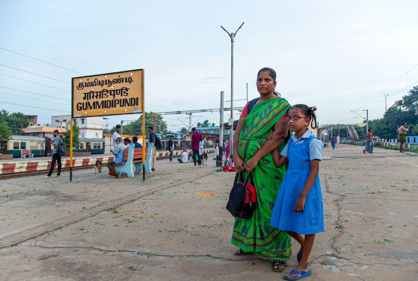 Saranya Balaraman waiting for the local train with her daughter, M. Lebana, at Gummidipoondi railway station. They travel to Chennai every day to attend a school for children with visual impairment. It's a distance of 100 kilometres each day; they leave home at 6 a.m. and return by 7 p.m.
