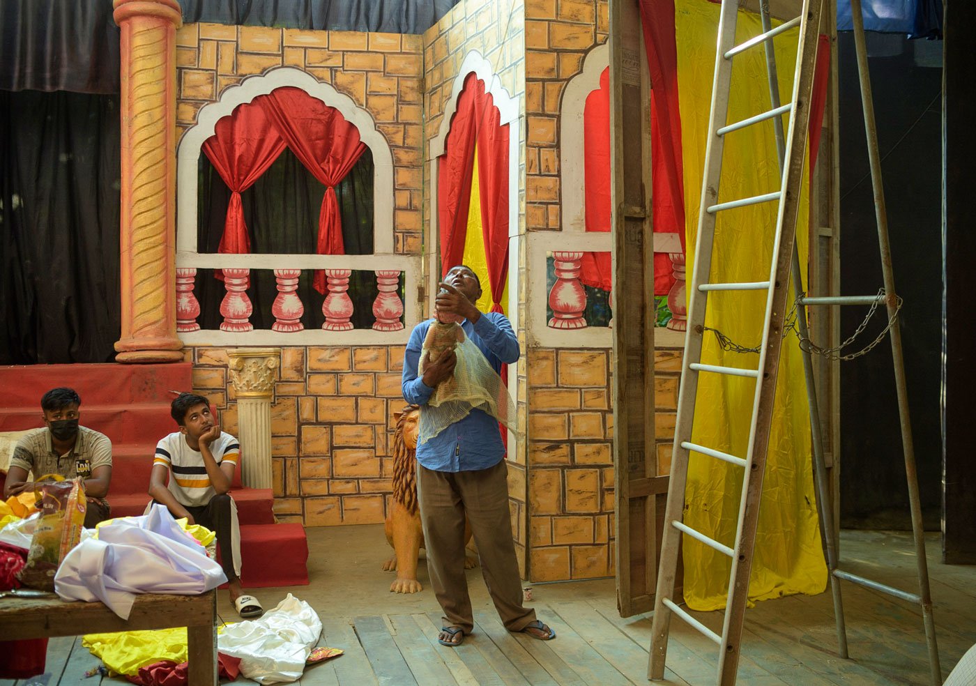 The Garamur Saru Satra is one of the more than 60 venues in Majuli, Assam where the mahotsav was held in 2022. Krishna Dutta, (standing) works on stage decorations