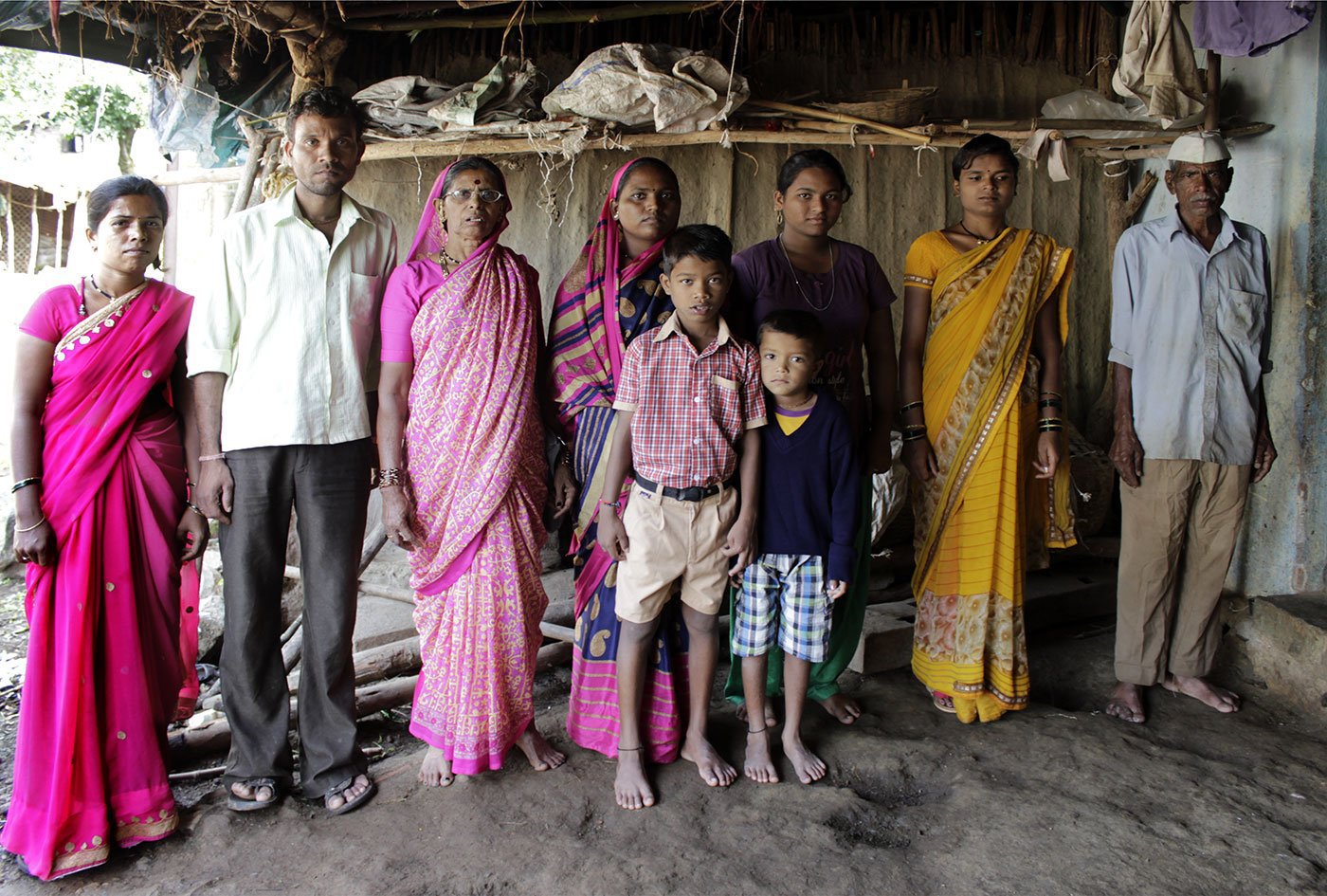 Shahu Kamble's sons, daughters-in-law and grandchildren in Nangaon village. Her sister-in-law and friend Kusum Sonawane, who also sings grindmill songs, is standing third from the left