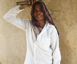 A farmer ready to start harvesting in Rampur village