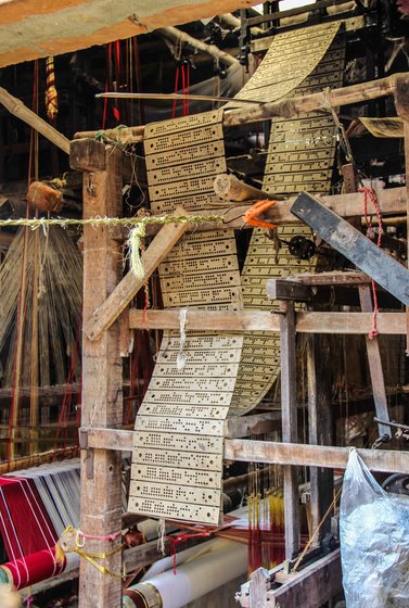 Perforated graphs such as these are given by artists to the weavers, which help them insert threads into the loom