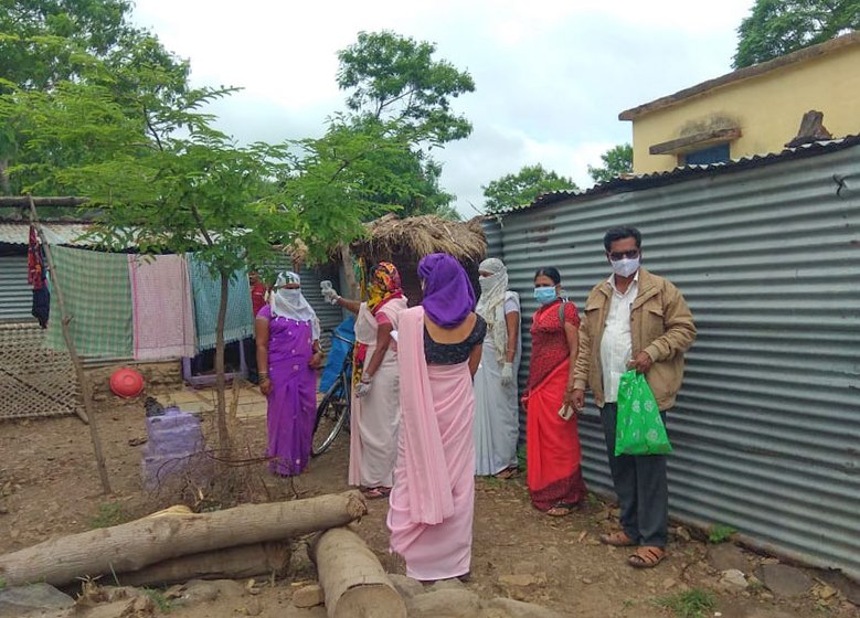 Anita Kadam (in red saree): 'ASHAs do their tasks without complaining.' Right: Tanuja Waghole (third from right) has been out on Covid surveys every day