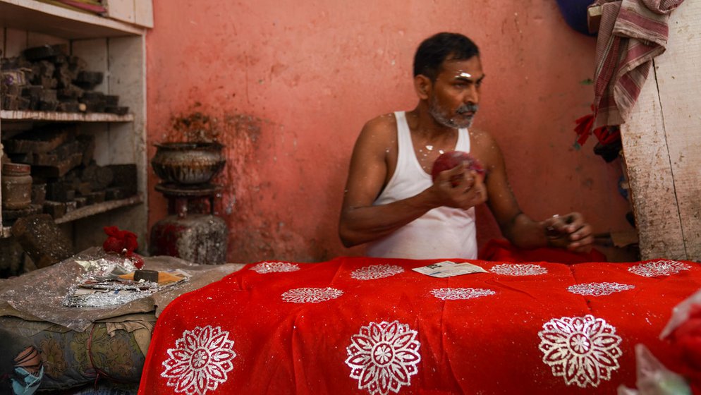 Mohammad Asghar (left) is a chhapa craftsman during the wedding season. The rest of the year, when demand shrinks, he works at construction sites. He uses wooden moulds (right) to make attractive designs on clothes that are worn on festive occasions, mostly weddings of Muslims in Bihar's Magadh region