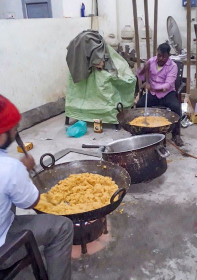Food cooked in Shaoron is sent to Ghazipur once a week. Surendra Kumar (right) cooks for the protestors while also managing his halwai shop in the village