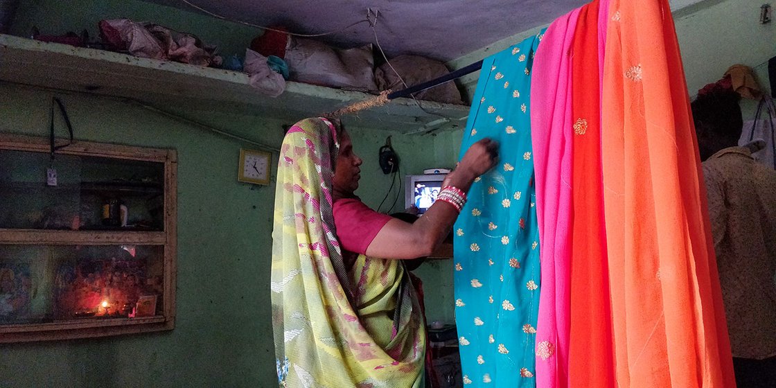 Renuka Pradhan’s one-room home in the Mina Nagar area of north Surat turns into her working space every morning. She cuts threads out of more than 75 saris every day. The constant work has led to cuts and bruises on her fingers