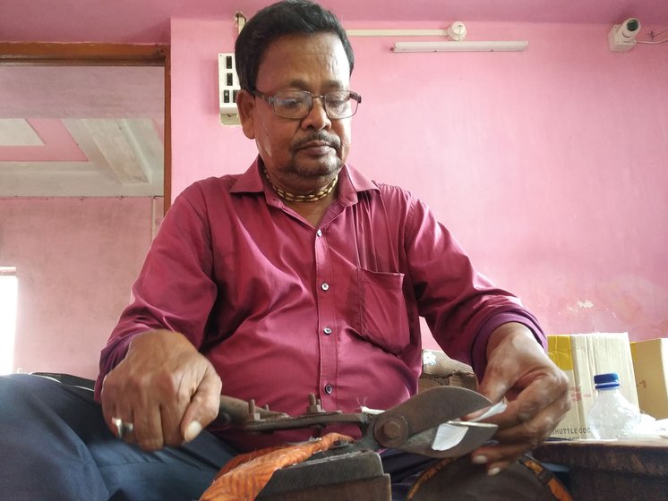 Naba Kumar has a workshop for making shuttlecocks in Jadurberia neighbourhood of Howrah district. He shows how feathers are trimmed using iron shears bolted at a distance of 3 inches . Shuttles are handcrafted with white duck feathers, a synthetic or wooden hemispherical cork base, nylon mixed with cotton thread and glue
