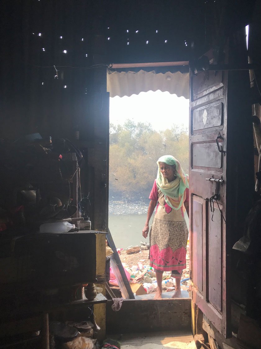 Left: Kitabun outside her 100-square feet room next to a nallah. Right: It shelters 16 people, including her grandkids
