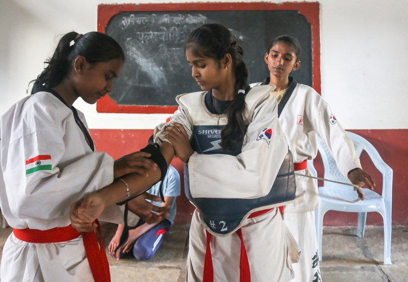Saniya Mullani (centre), 17, prepares for a Taekwondo training session in Kolhapur’s Bhendavade village