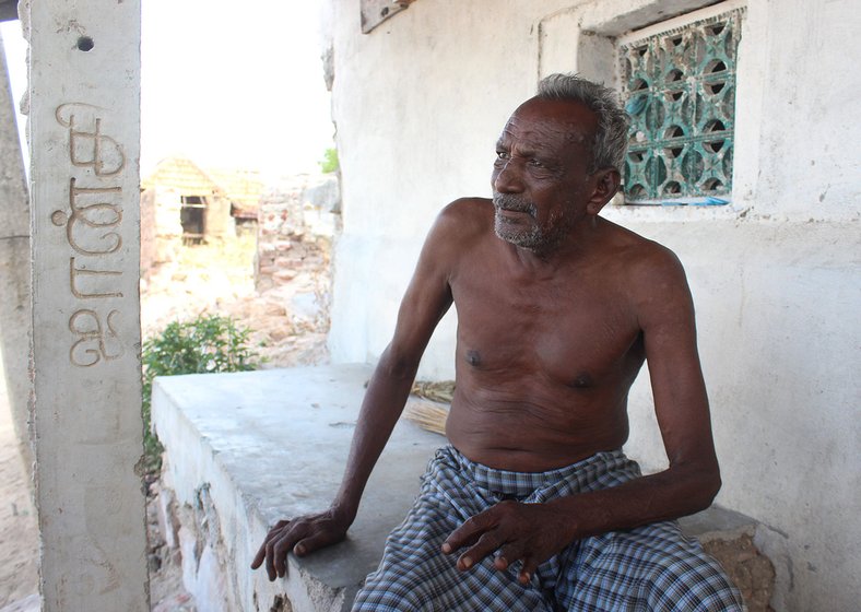 Kandasamy seated on the porch of his house   