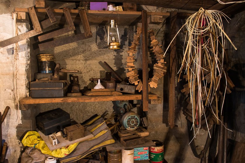 Bapu's workshop is replete with different tools of his trade, such as try squares  (used to mark 90-degree angles on wood), wires, and motor rewinding instruments.