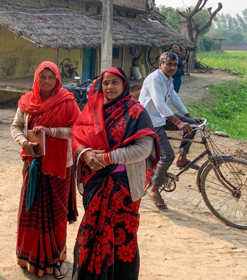 Kalavati Soni, wearing the floral printed sari, with ASHA worker Vinita Soni to her right