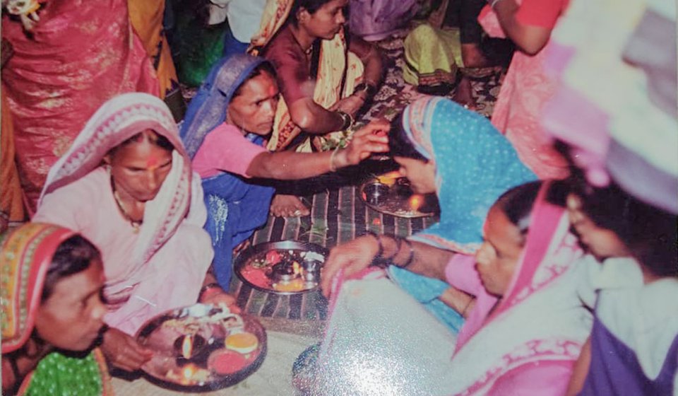 Left:  A haldi-kumkum function with Savitrabai Ubhe and others from her village (file photo). Right: Savitrabai receiving flowers at the event