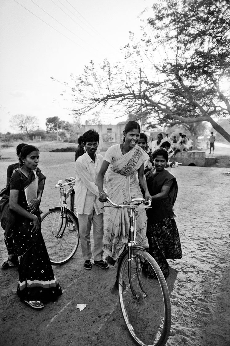 Women learning how to ride bicycles in a village in Tamil Nadu