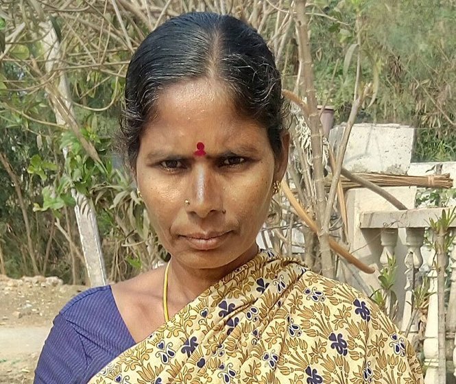 A woman showing her Aadhar card 