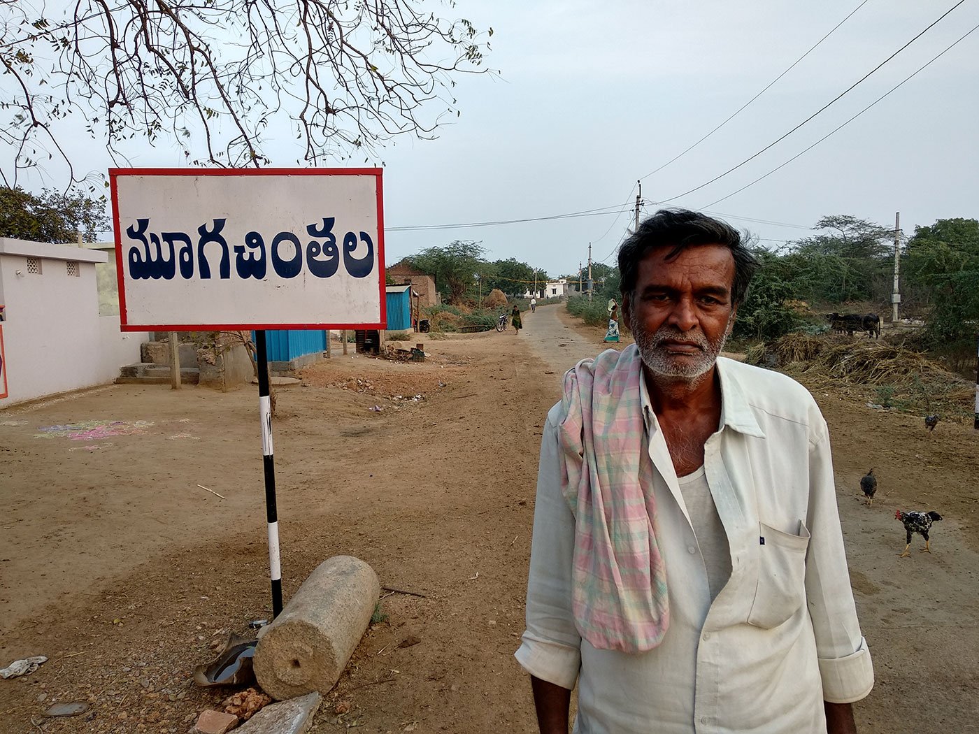 A farmer standing on a road