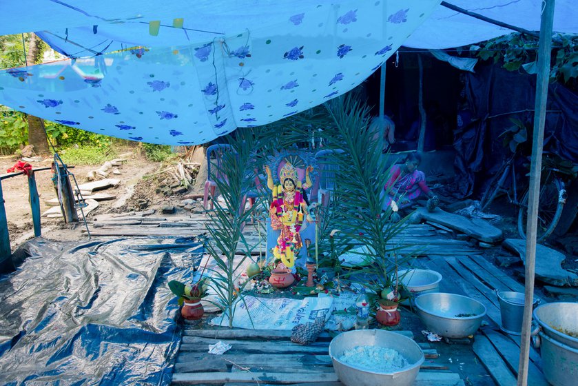 Left: Snake goddess Manasa is a popular among the Dalits of South 24 Paraganas as well as Bankura, Birbhum, and Purulia districts. On the day of Viswakarma Puja (September 17 this year) many households in remote villages in the Indian expanse of the Sundarbans worship the snake goddess and perform pala gaan.  Right: Older women in Rajat Jubilee village welcome others in the community to the Puja.