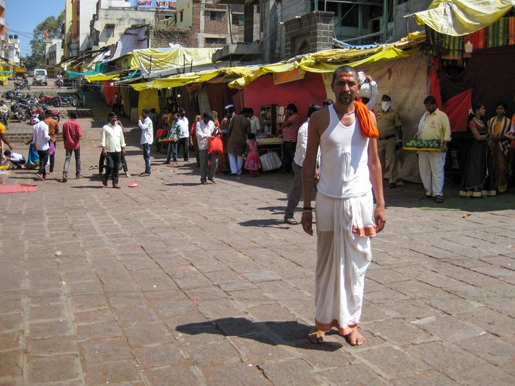 'It is first time in the history that we are witnessing this', says Sanjay Pende (left), a priest at the Tulja Bhavani temple, which usually sees a throng of devotees (right)

