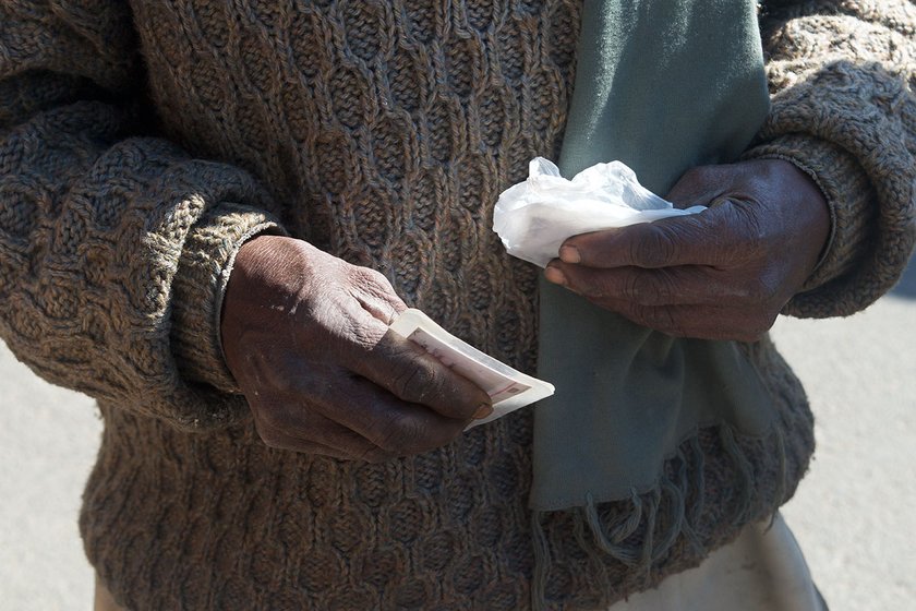 Close up of a man's hands holding his Aadhaar card