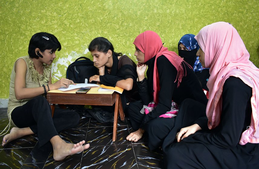 Faiza Khan teaching English Grammar to a smaller group. A batch has about 20 girls