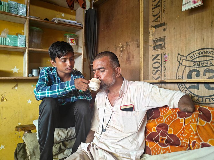 Right: Wasim’s son Aleem helping him drink chai at his house in Khargone