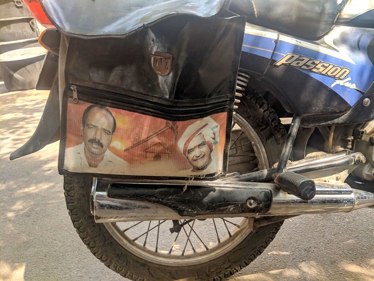 Outside a rexine shop, motorbike saddlebags with pictures of film stars and politicians