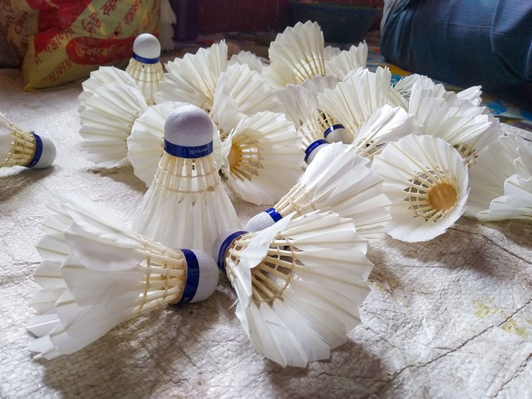 Naba Kumar has a workshop for making shuttlecocks in Jadurberia neighbourhood of Howrah district. He shows how feathers are trimmed using iron shears bolted at a distance of 3 inches . Shuttles are handcrafted with white duck feathers, a synthetic or wooden hemispherical cork base, nylon mixed with cotton thread and glue