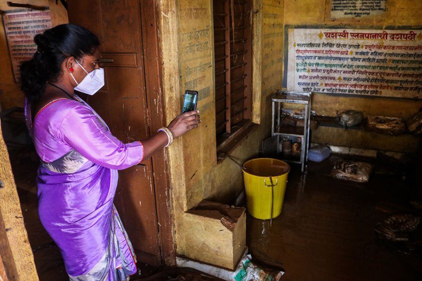An ASHA worker examining the damage in the public health sub-centre in Kolhapur's Bhendavade village, which was ravaged by the floods in 2021