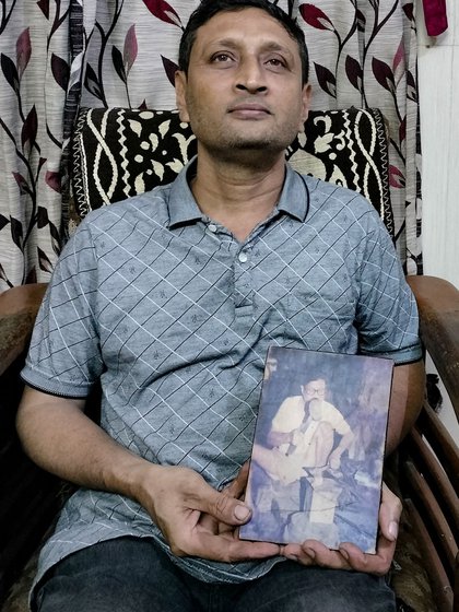 He learnt the craft from his father Dattatrey Chaphekar, whose photo he is holding (right)