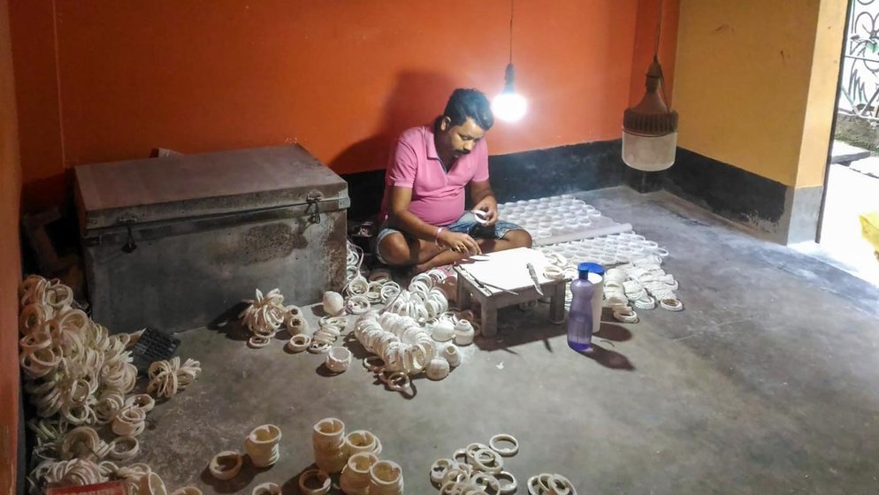 Biswajeet Sen injecting hot water mixed with sulfuric acid to wash the conch shell for killing any microorganisms inside