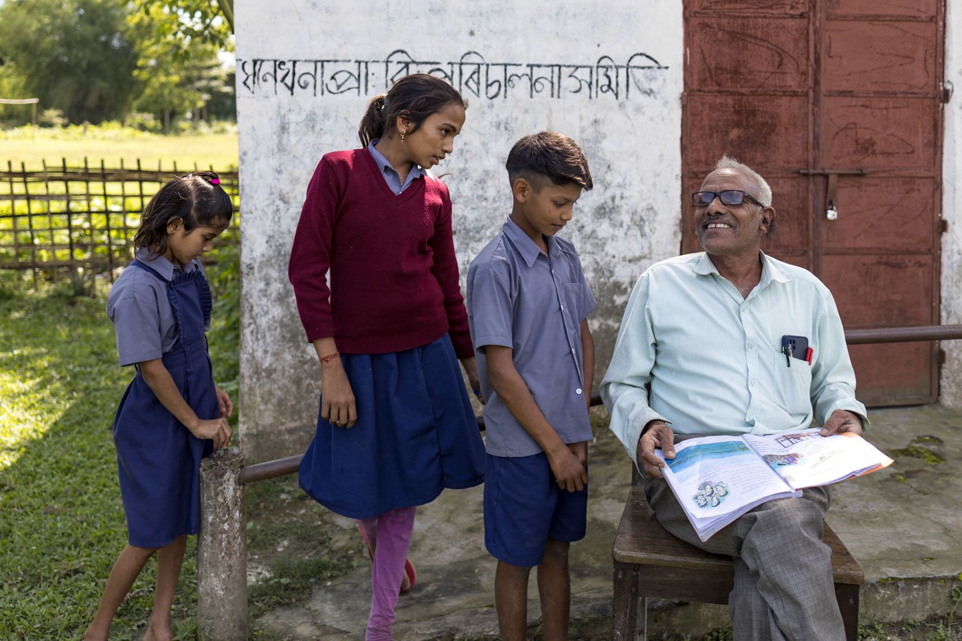 Siwjee (seated on the chair) with his students Gita Devi, Srirekha Yadav and Rajeev Yadav (left to right) on the school premises