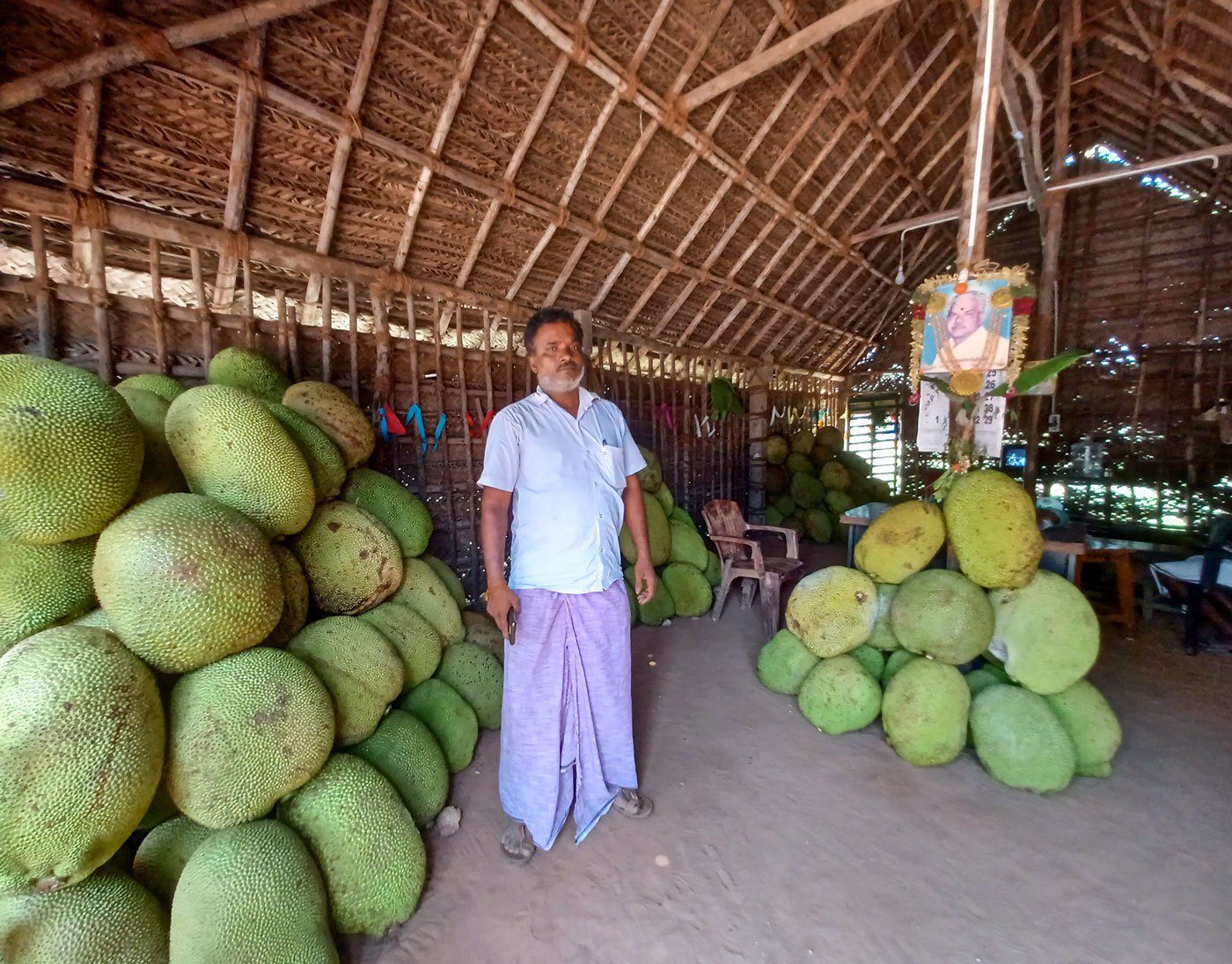R. Vijaykumar, a farmer and commission agent, in his shop in Panruti, where heaps of jackfruit await buyers