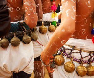 Bigger bells tied to dancers’ waists chime along with their movements to the tune of a drum.