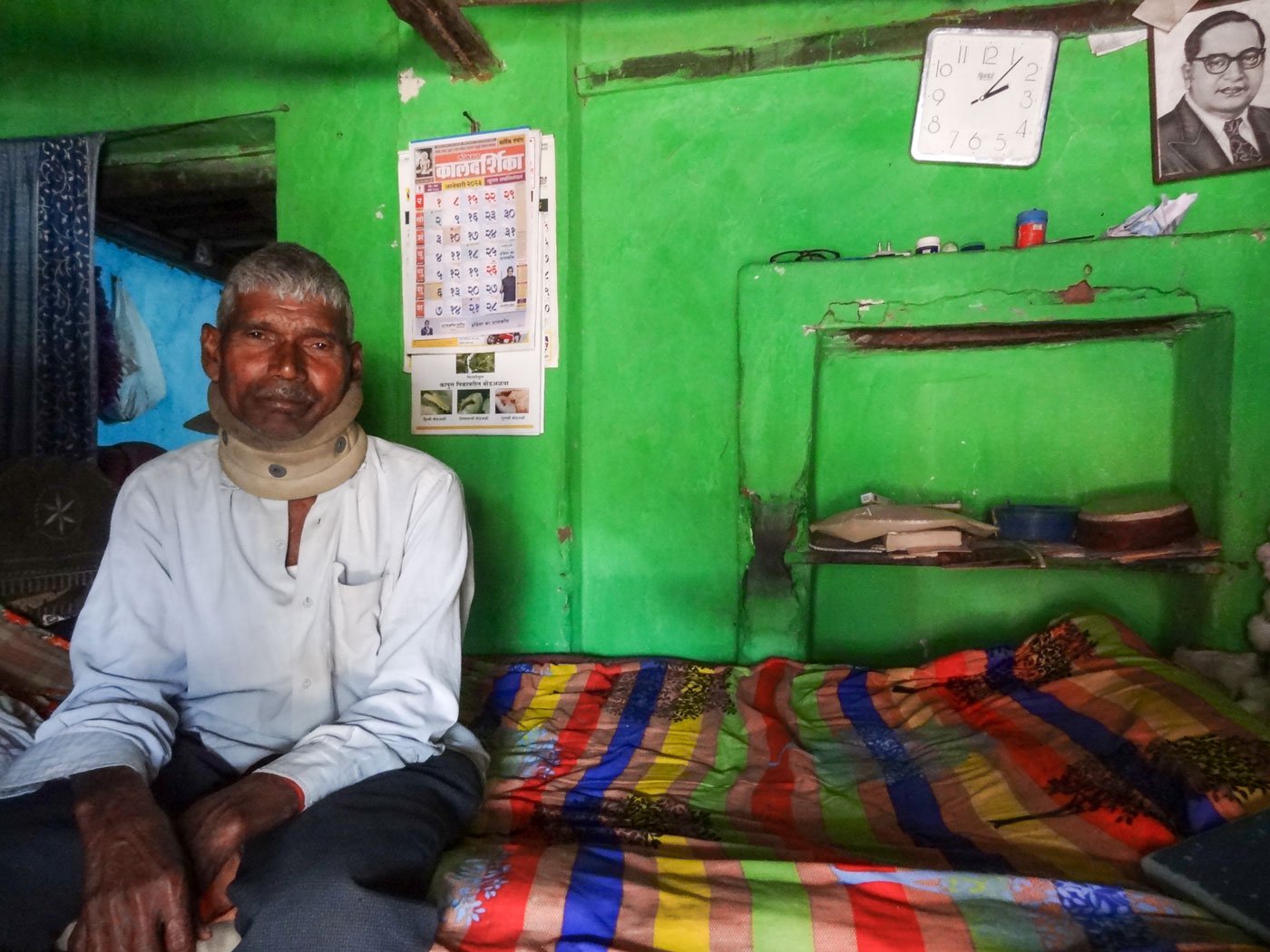 Dadaji Dodake, 70, wears a cervical support after he fell from the perch of his farm while keeping a night vigil