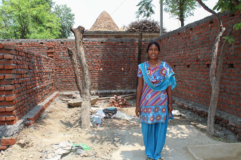Mangola Singh in front of a semi constructed room which she has been trying to build for herself in the courtyard of her home in the village of Nandpur (Udham Singh Nagar), Uttarakhand