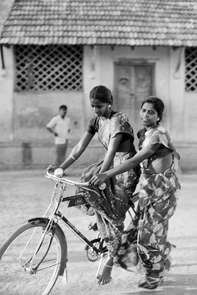 Women learning how to ride bicycles in a village in Tamil Nadu