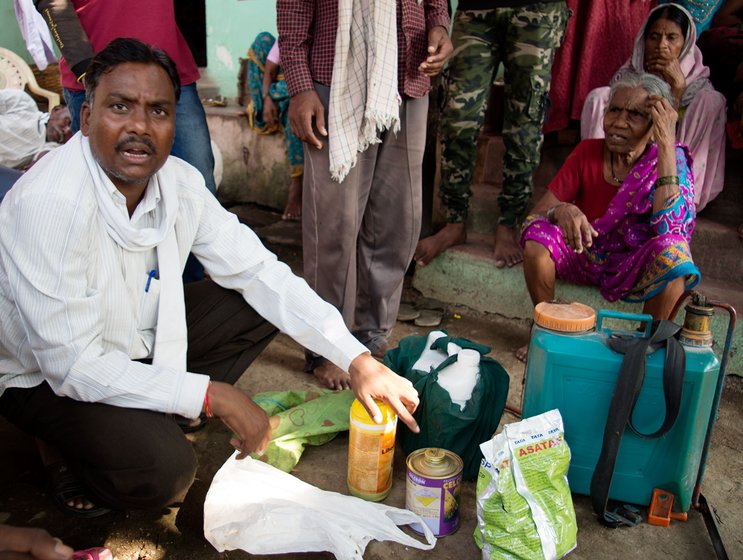 One of the relatives of the Soyams shows the different chemicals – pesticides, growth promoters, etc – that the Soyam brothers used for spraying on their cotton plants