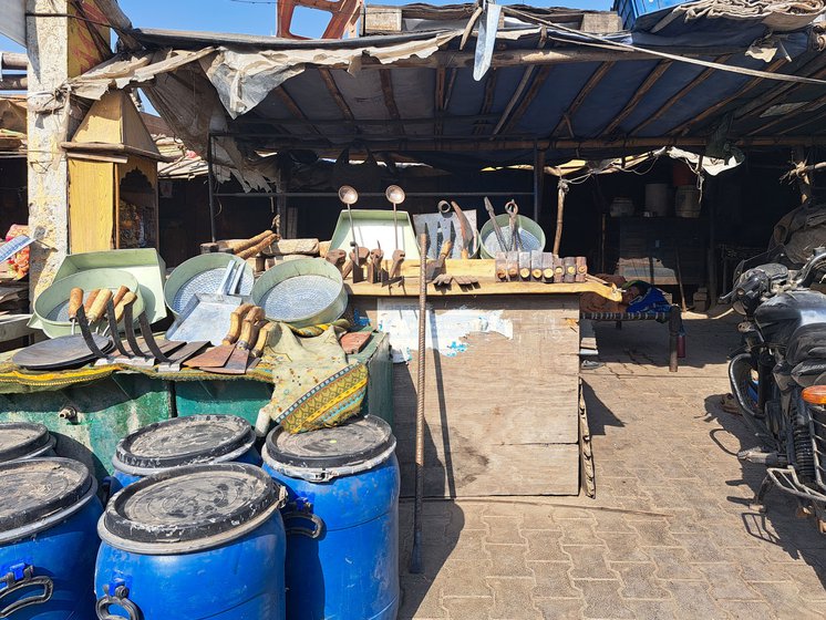 They sell ironware like kitchen utensils and agricultural implements including sieves, hammers, hoes, axe heads, chisels, kadhais , cleavers and much more. Their home (and workplace) is right by the road in the market