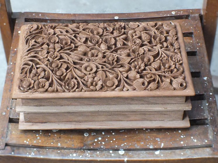He draws his designs on butter paper before carving them on the wood. These papers are safely stored for future use