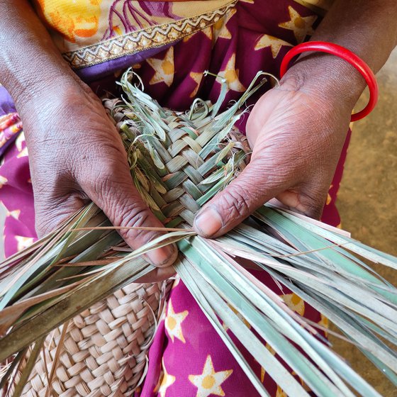 The leaves are separated from the stem and woven into strips. Jolen then carefully braids them into a complex repetitive pattern