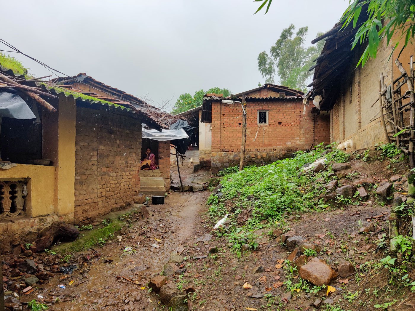 The lane to Dilip's house (left) in Kadvyachimali hamlet (right), with houses whose residents migrate for work every year