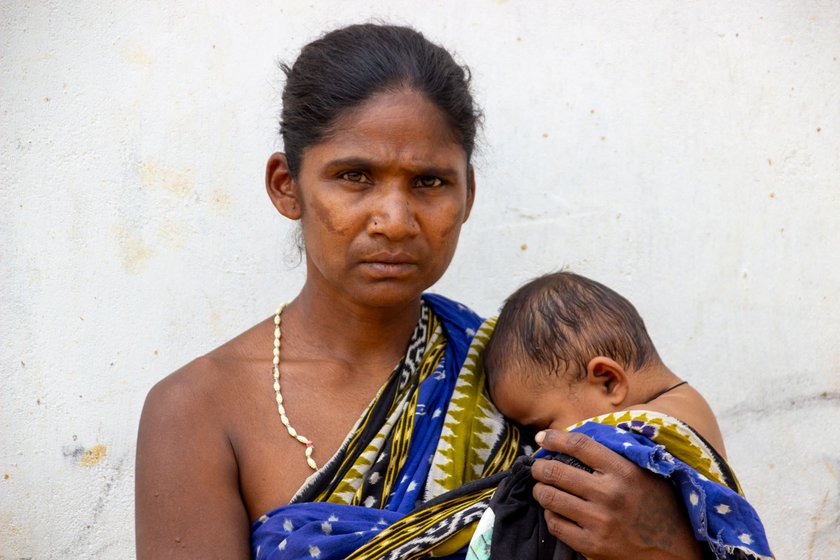 Namani holding her eight-month-old granddaughter, Dhartiri.