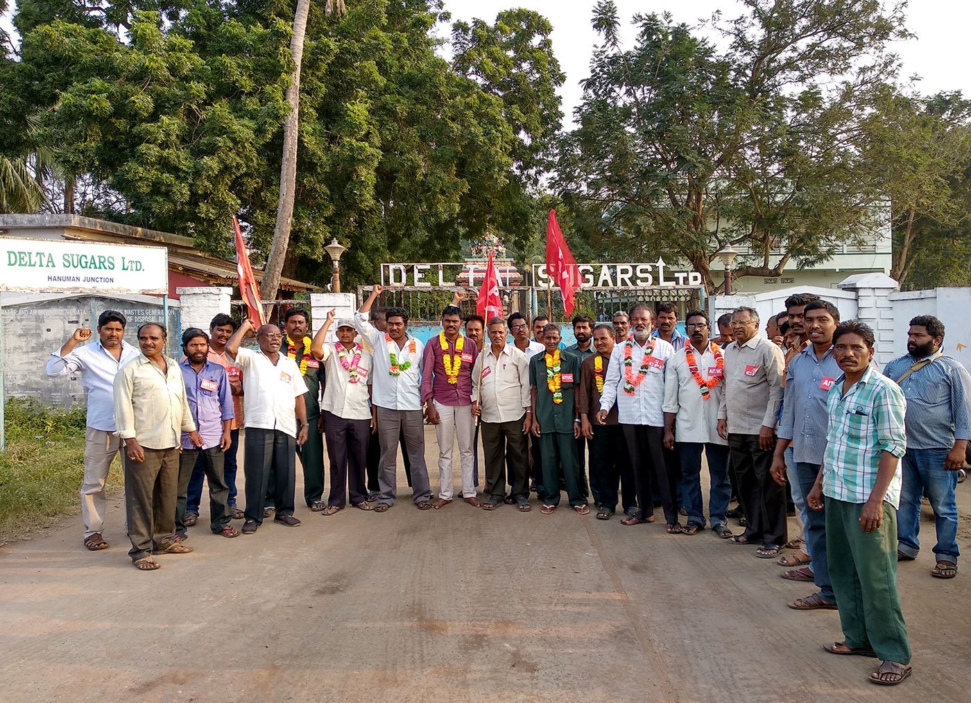Workers protesting in front of the main entrance of the Delta Sugar Mills facing the National Highway