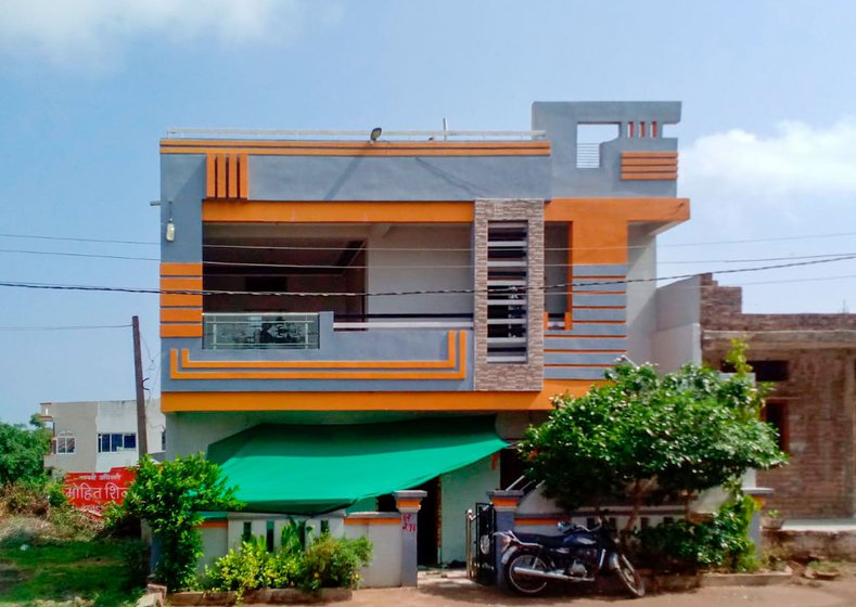 He looks for houses that have some ornamentation. This design (right) was inspired by the house (left) of a local teacher who gave him waste notebooks