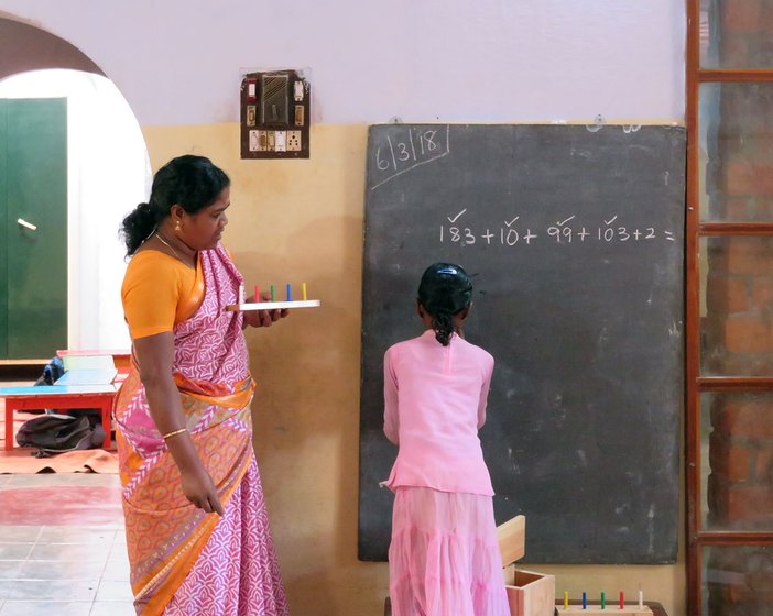 Shanthi Kunjan teaching a young student math
