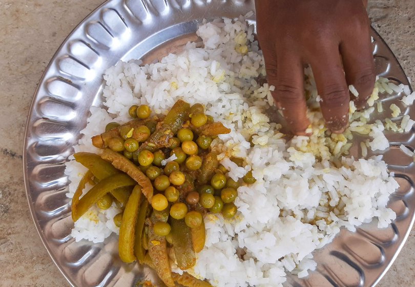 Their mid-day meal of rice, dal and vegetable
