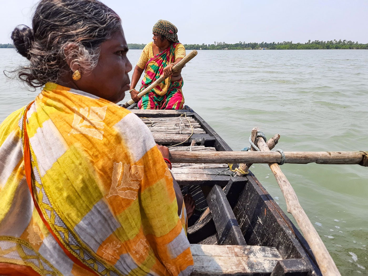 Right: Parul (background) learned fishing from her mother and Lokhi (yellow sari foreground) learned it from her father