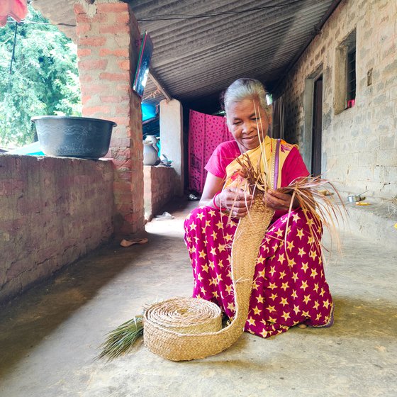 The leaves are separated from the stem and woven into strips. Jolen then carefully braids them into a complex repetitive pattern