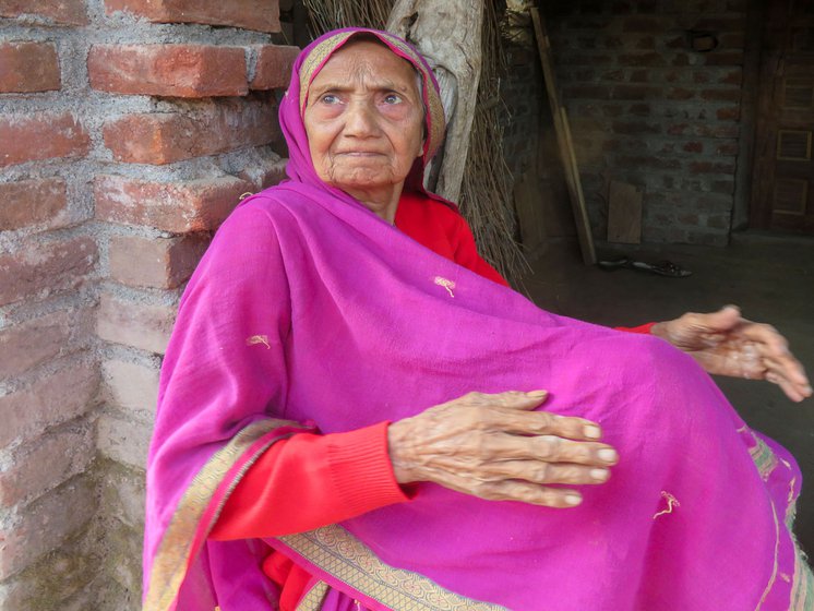 Right: Rukhabai sitting on the threshold of her house